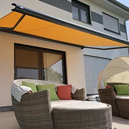 a patio with two chairs and a hammock