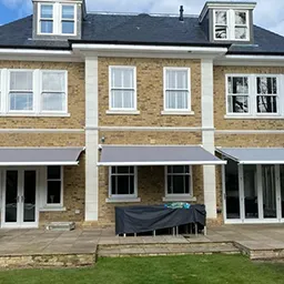 a large brick building with a covered patio