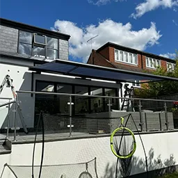 a white house with a black awning