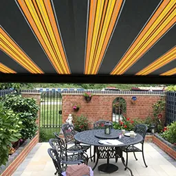 a patio with a table and chairs under an awning