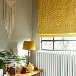 a room with a radiator, a lamp, a table, and a