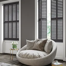 a living room filled with furniture and windows